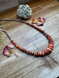 22 Inch graduated necklace orange and purple spiny and sterling silver pearls