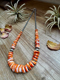 22 inch graduated orange spiny necklace with Sterling silver pearls